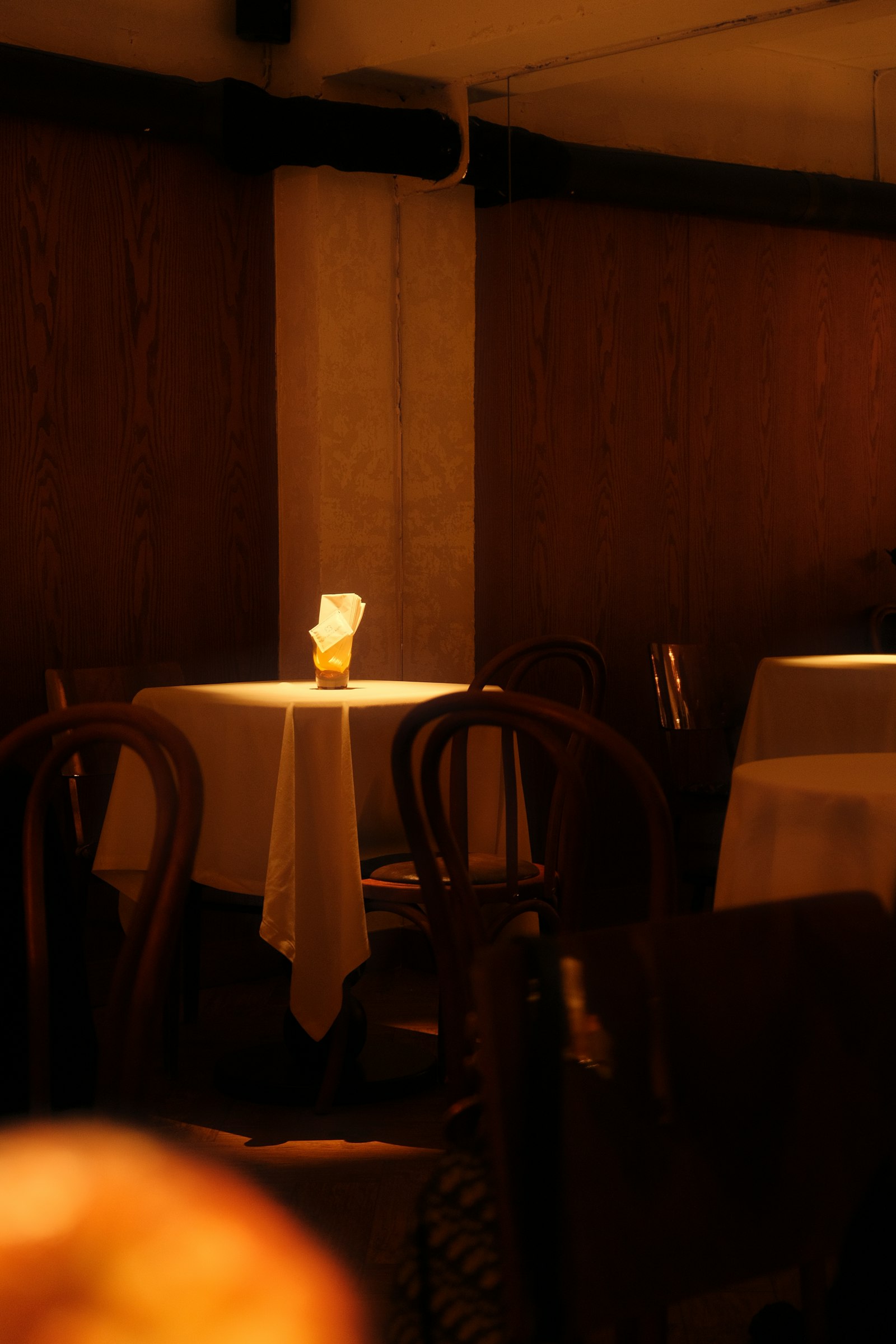 An intimate private dining table set with glassware for an evening event